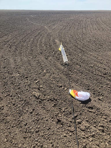 High power rocket in plowed field